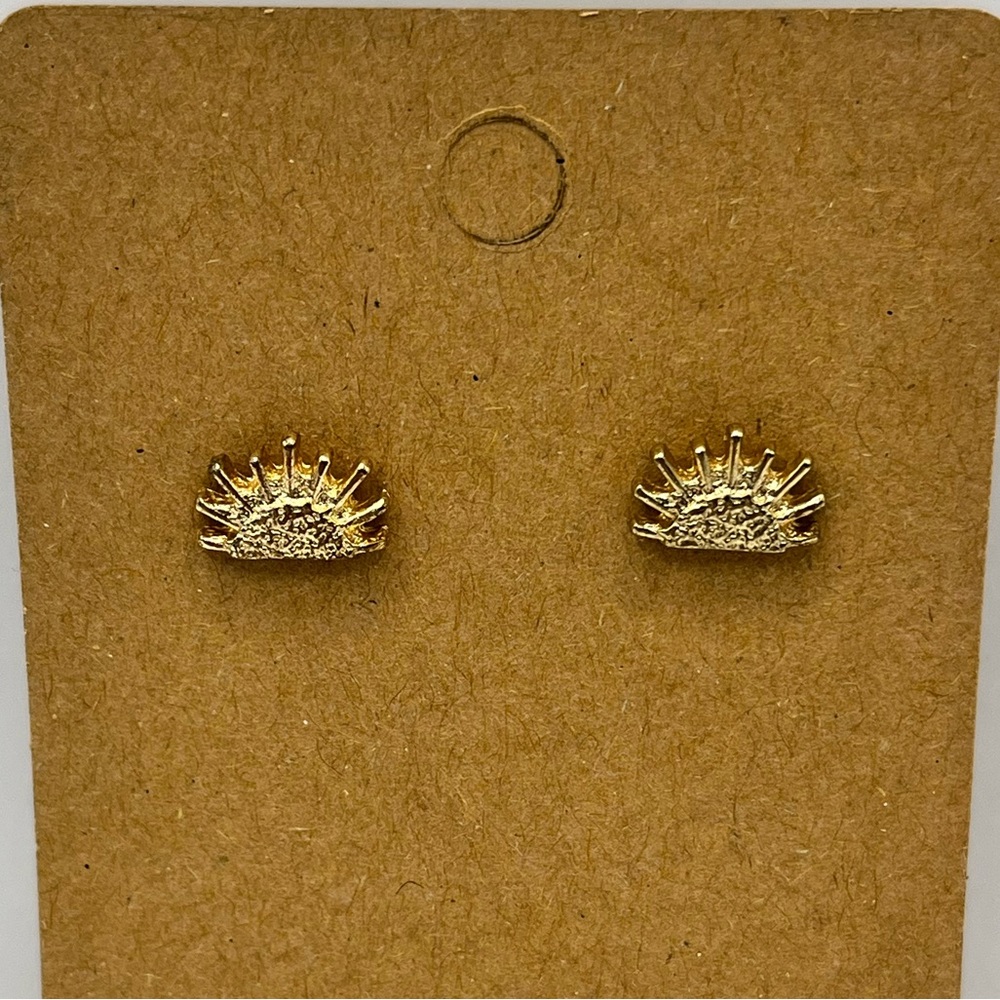 Gold colored sun setting stud earrings